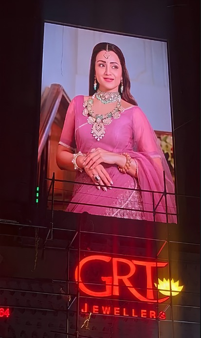 Outdoor LED billboard displaying GRT Jewellers jewellery advertisement at night